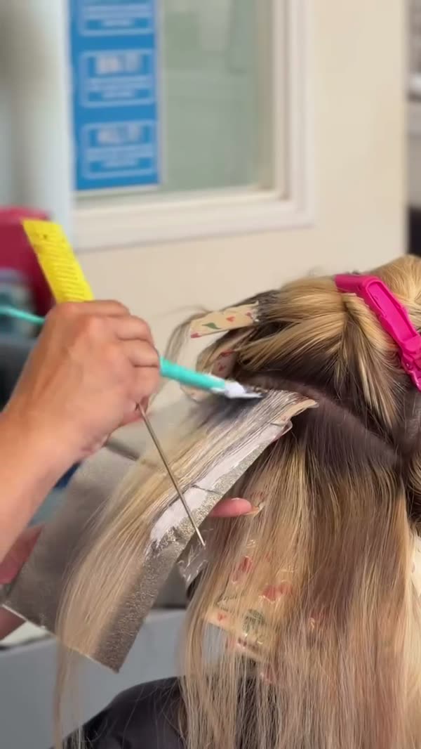 Hair being sectioned and foiled during a colour.